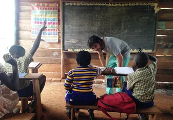 Volunteer teacher in Ugandan classroom