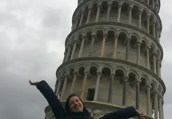 woman having her picture taken on a tall building