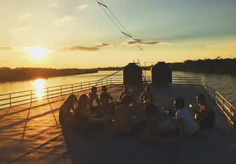 group eating under the sunset