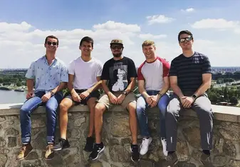 Guys sitting at a porch.