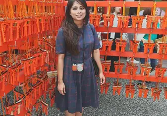 A lady posing at a Japanese stall.
