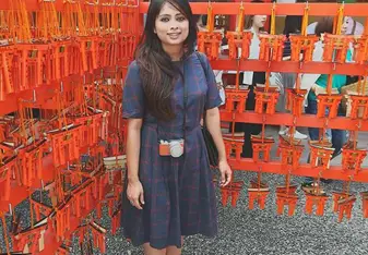 A lady posing at a Japanese stall.