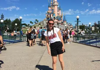 A woman poses at the Paris Disneyland.