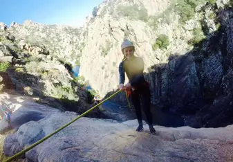 A woman abseiling.