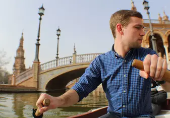 A guy rows a boat.