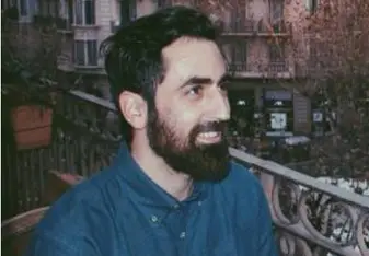 bearded man wearing blue polo shirt