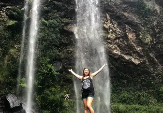 a woman bathing on a beautiful falls