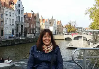 a woman having her picture taken on a lagoon as her background