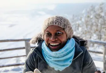 a woman wearing white scarf and bonnet