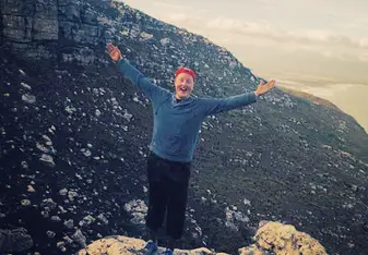 a man standing on top of a mountain