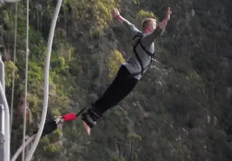 a man bungee jumping on a high mountain