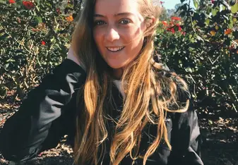 blonde lady weraing black suit