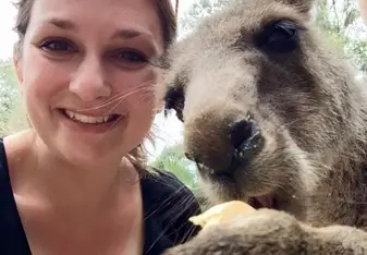 a woman cuddling a donkey