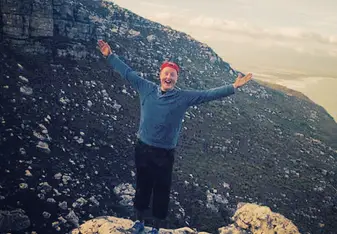 a man standing on top of a mountain