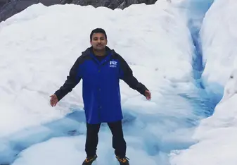A man stepping on a glacier.