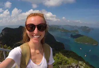 A girl takes a photo showing many islets.