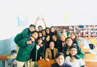 Group of people posing for a photo inside a room.