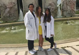 Three persons in lab coat.