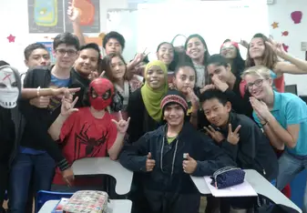 a Muslim woman surrounded by group of young students
