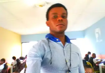 man taking selfie wearing light blue shirt