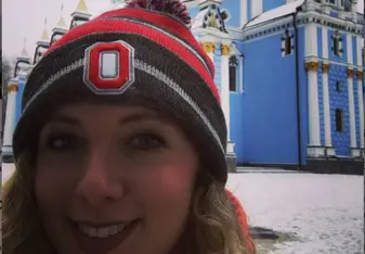 blonde woman wearing black and red bonnet