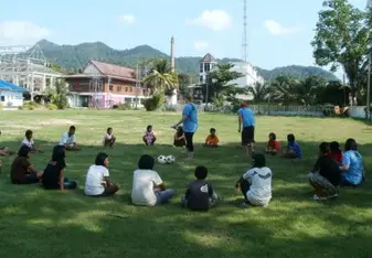 Children gathering around an open field.