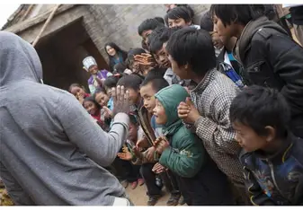 A man gathers children.