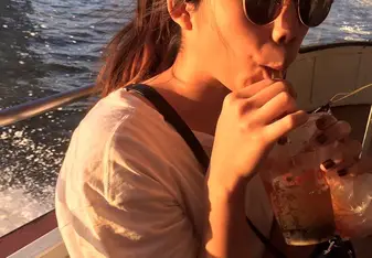 A girl sipping a drink.