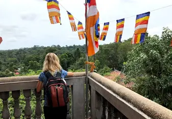 A girl leaning at a balcony.