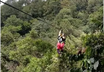 A woman ziplines.