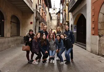 Group of people posing for a photo at an alley.