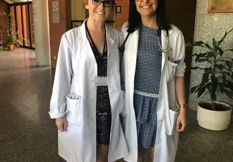 Two women wearing lab coats.