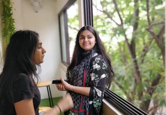 A smiling lady and a sad one.