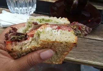 A pesto sandwich with a side of Greek coffee