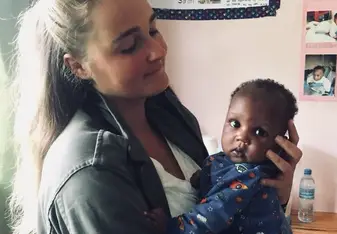 A woman holding a toddler.