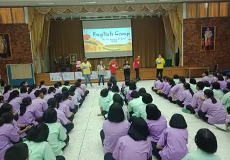 Adults facilitating an activity inside a hall.