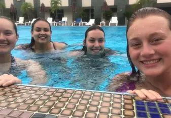 Four girls at a swimming pool.