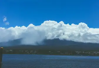 Mount Fuji (known as Fuji-san) under a shroud of clouds.