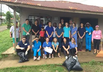 The group picks up trash on the street in a small community. 