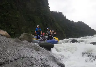 Group of people water rafting.