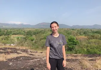 A young woman in an open field.