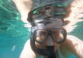 A woman snorkeling.
