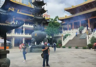 A traditonal Chinese temple with looming skyscrappers in the background