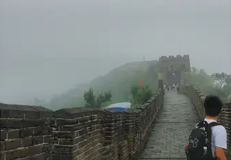  a section of the famous great wall, with heavy mist in the background 
