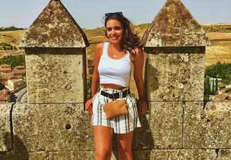 A woman poses at a tourist spot.
