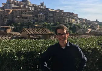 A guy posing for a photo at a tourist spot.