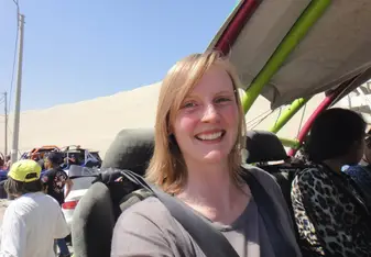A woman takes a selfie inside a vehicle.