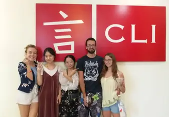 A group posing at an office signage.