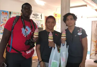 Three guys with cones of ice cream.