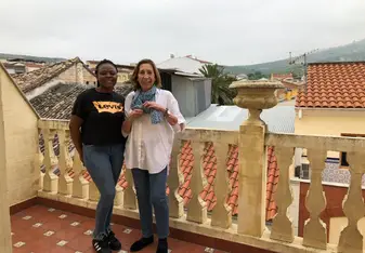 Two women at a porch.